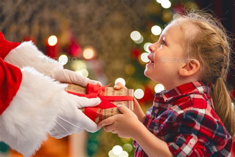 Santa Claus Giving T To Child Stock Photo By Choreograph Photodune