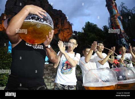 A participate uses a fish tank to drink beer during a beer drinking ...