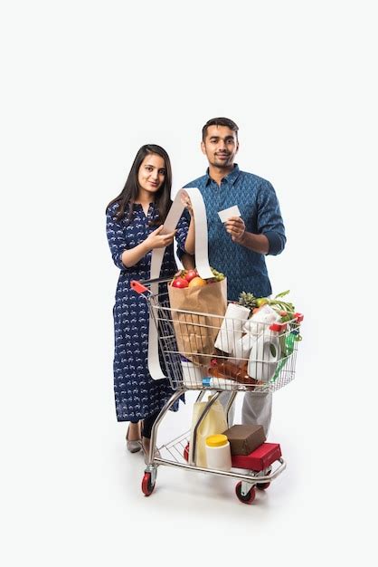 Premium Photo Indian Young Couple With Shopping Cart Or Trolly Full