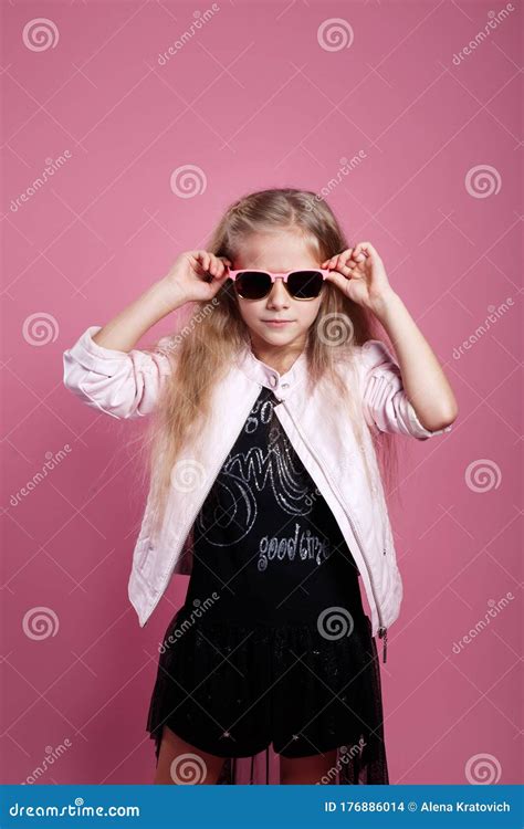 Fashionable Little Girl Wearing Black Dress Sunglasses And Pink