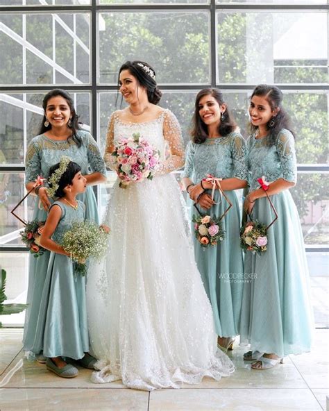 A Group Of Women Standing Next To Each Other In Front Of A Large Glass