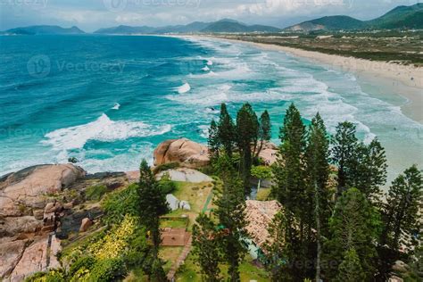 Joaquina Beach With Trees And Ocean With Waves In Brazil Aerial View