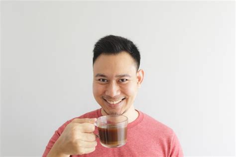 Premium Photo Portrait Of A Smiling Young Man Drinking Glass Against