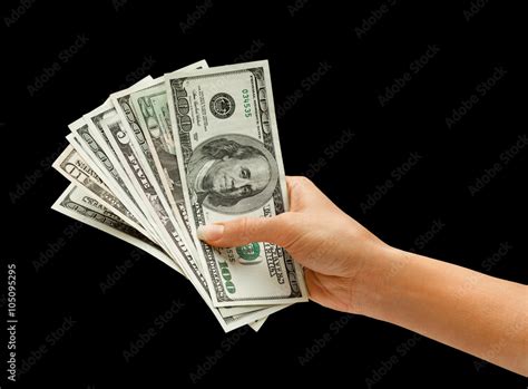 Hand is giving money isolated on black background Stock Photo | Adobe Stock