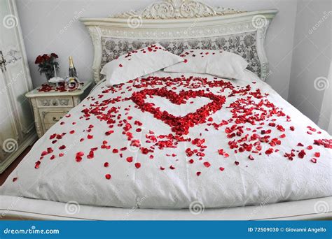 Bed with Real Red Rose Petals Stock Photo - Image of kingsize, candles ...