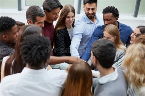 Young College Students Teamwork Stacking Hand Concept Stock Photo