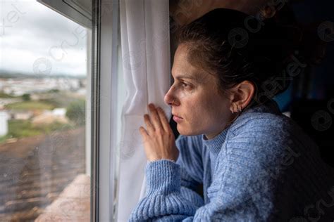 Sad Woman Looking Out The Window Stock Photo 2644289 Crushpixel