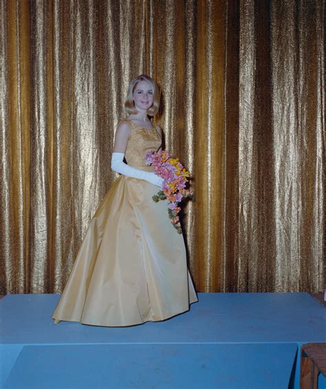 Woman In Formal Attire Posing In Front Of A Curtain Backdrop Unt