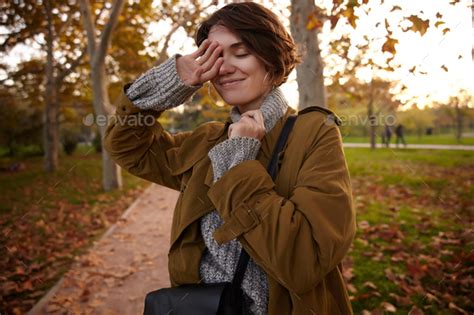 Good Looking Young Positive Short Haired Brunette Woman Raising Hand To