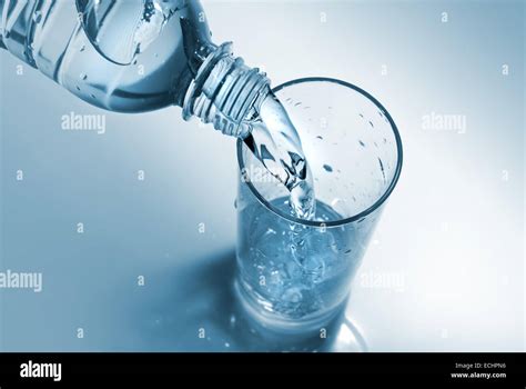 Water Pouring Into Glass From Bottle Stock Photo Alamy