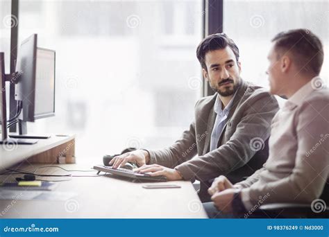 Picture Of Two Young Businessmen Having Discussion Stock Image Image