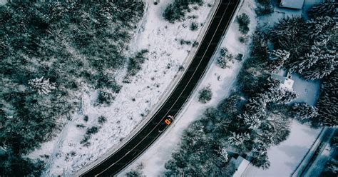 An aerial view of a road in the snow photo – Aerial view Image on Unsplash