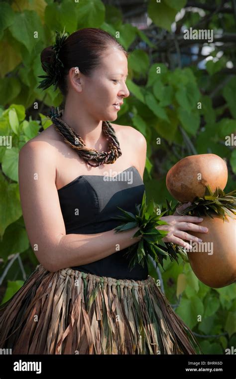 Hula Dancer In Traditional Ti Leaf Skirt Holds Ipu Heke Before Kahiko