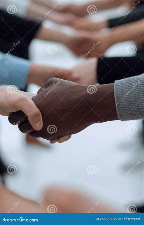 Close Up Diverse Young People Shaking Hands With Each Other Stock