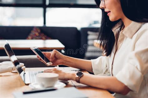 Lifestyle Freelance Working Woman And Laptop Computer He Using Smartphone For Check Status Stock