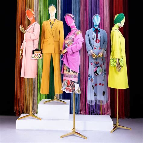 Three Mannequins Dressed In Brightly Colored Clothing