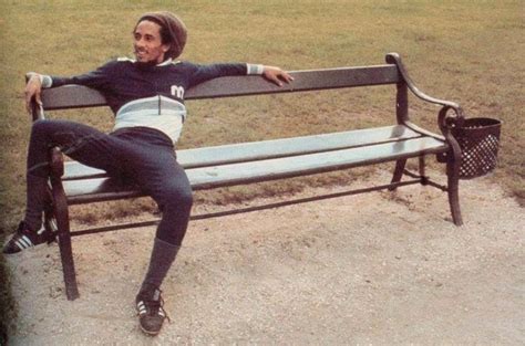 A Man Sitting On Top Of A Metal Bench