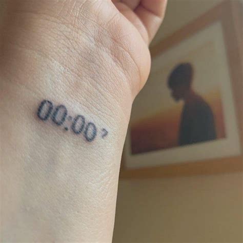 A Person With A Small Tattoo On Their Wrist That Reads