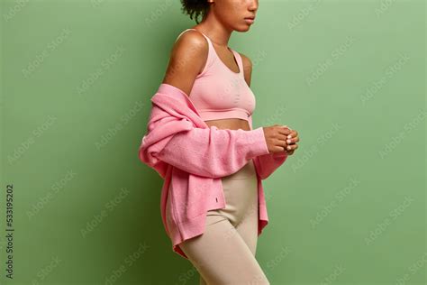 Cropped View Of Faceless Unrecognizable Woman Dressed In Cropped Top And Leggings Pink Jumper On