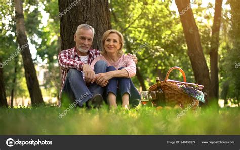 Joyful Senior Couple Sitting Grass Enjoying Romantic Date Picnic Park