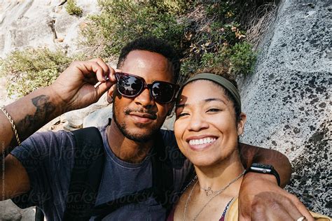 An African American Couple Taking A Selfie Out In Nature By Stocksy