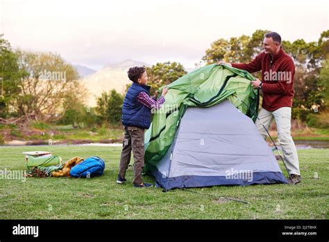 Camp Is Almost Ready Shot Of A Father And Son Setting Up A Tent