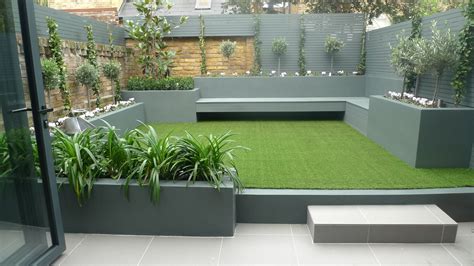 Modern small low maintenance garden fake grass grey raised beds ...