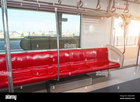 Interior of a passenger car of a commuter train. Red plastic seats and ...