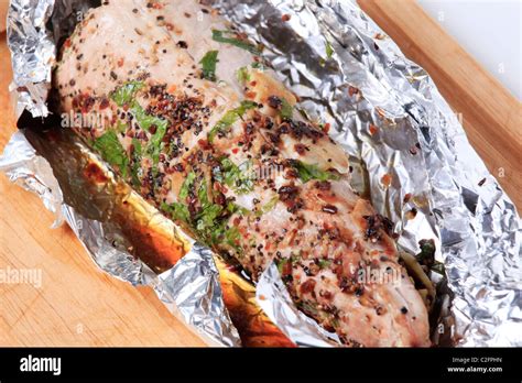 Spiced Pork Tenderloin Grilled In Tin Foil Stock Photo Alamy