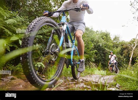 Man Mountain Biking On Muddy Trail Stock Photo Alamy