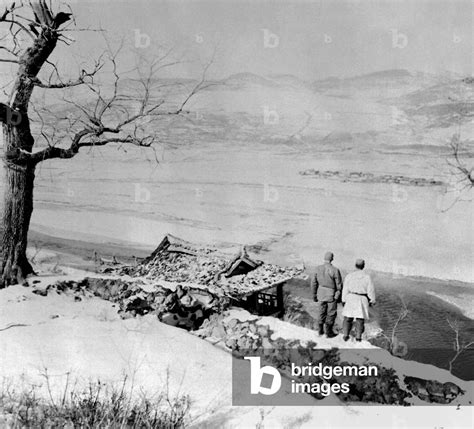 Two UN soldiers gaze across the Yalu River to the mountains of ...