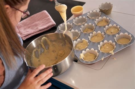 Premium Photo Down Syndrome Woman Making Homemade Cupcakes