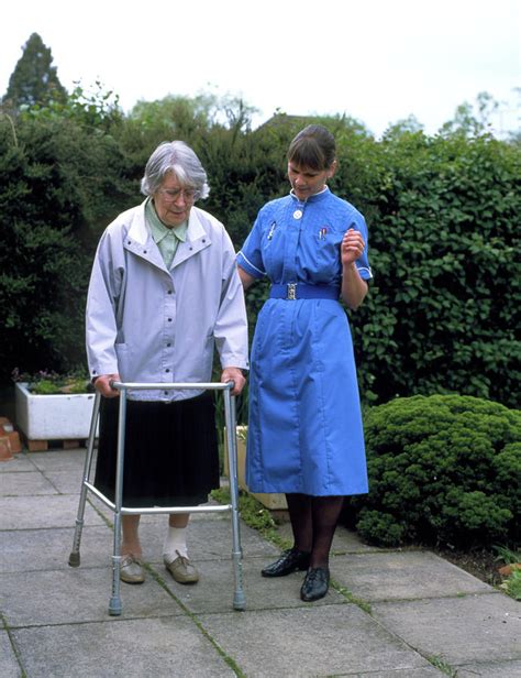 District Nurse Helps Old Woman Use Walking Frame Photograph By Chris Priest Science Photo