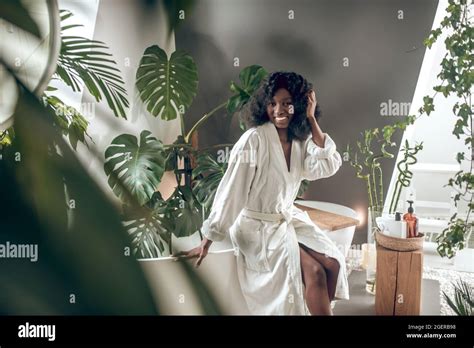 Smiling Dark Skinned Woman Sitting On Bathtub Stock Photo Alamy