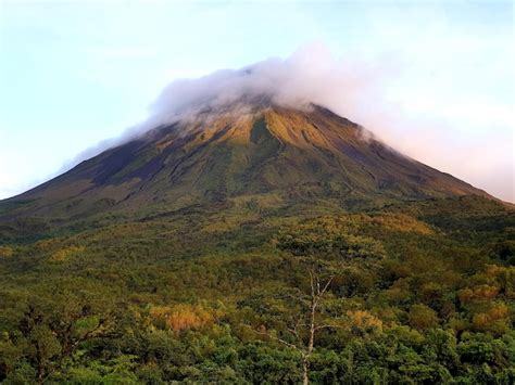 premium photo cloud covered volcano peak