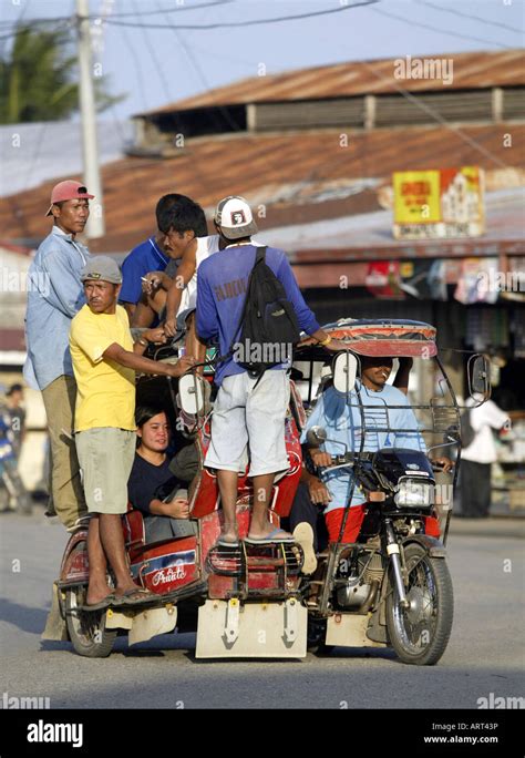 Filipinos Ride A Tricycle Taxi Through The Streets Of Mansalay