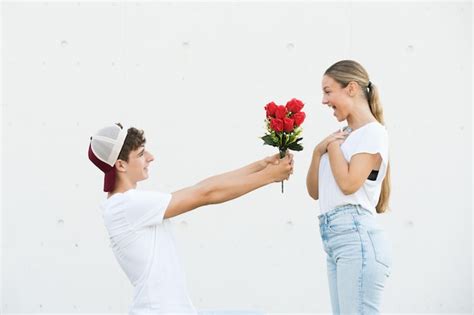 Premium Photo | Boy holding flowers making proposal at girlfriend