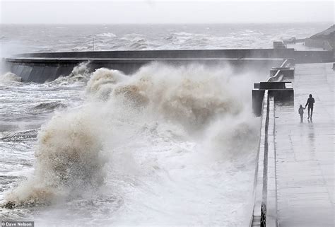 Adult Walks With Child Just Feet From Massive Crashing Seafront Wave