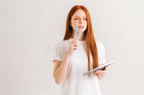 Studio Portrait Of Thoughtful Redhead Young Woman With Closed Eyes