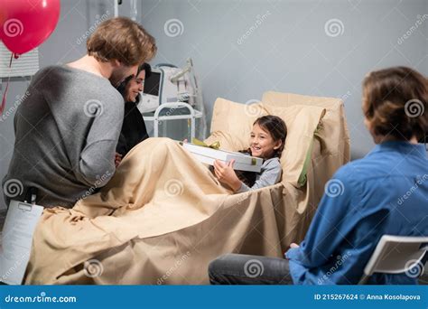 Adorable Little Girl in a Hospital Bed with Her Family Around Her Stock ...