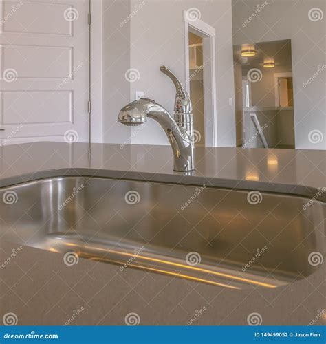 Square Frame Gleaming Stainless Steel Sink And Faucet Inside The