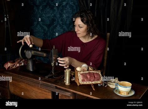 A 1920s Seamstress Working At Her Sewing Machine Stock Photo Alamy