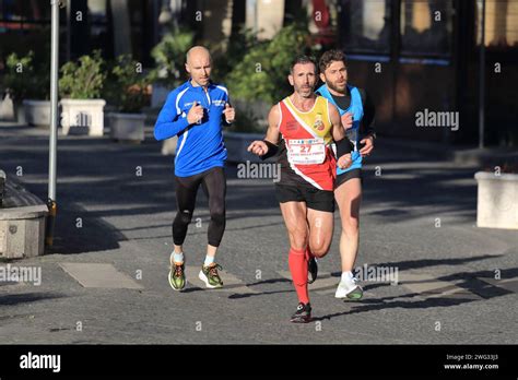 Men And Women Athletes Participate In A Running Race For Professionals