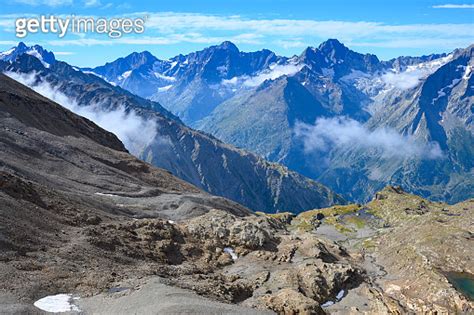 Hiking near ski station Les deux Alpes and view on Alpine mountains peaks in summer, Isere ...