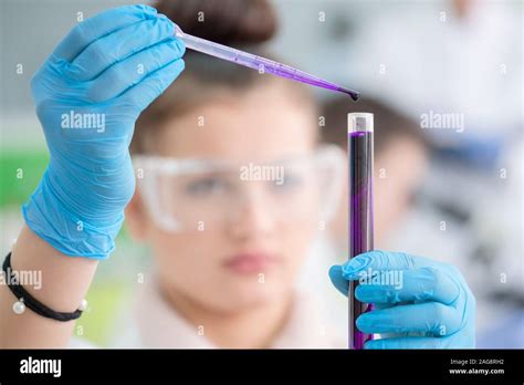 Young Female Laboratory Scientist Working At Lab With Test Tubes And