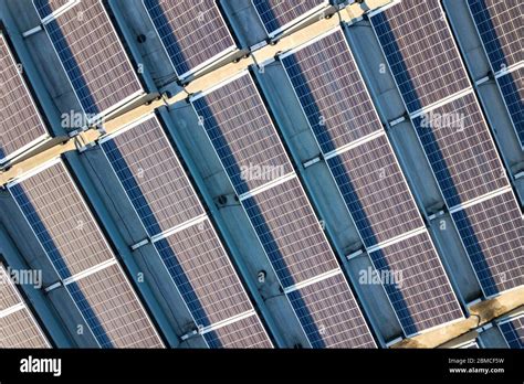 Aerial View Of Many Photo Voltaic Solar Panels Mounted Of Industrial