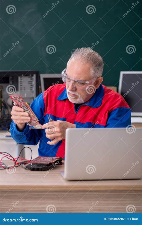 Old Repairman Repairing Computers In The Classroom Stock Image Image