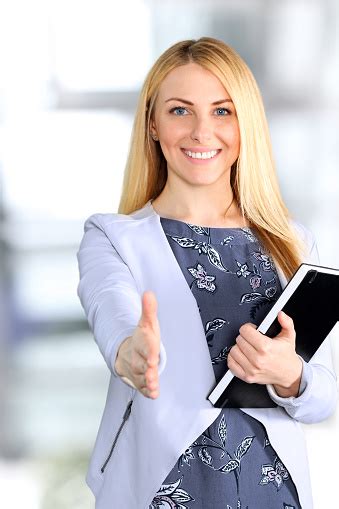 Business Woman Giving A Handshake In The Office Stock Photo Download