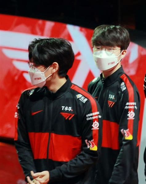 Two Men Wearing Face Masks Standing Next To Each Other