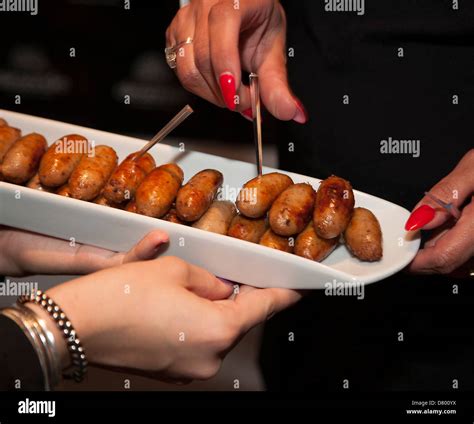 Tray of cocktail sausages at a party Stock Photo - Alamy